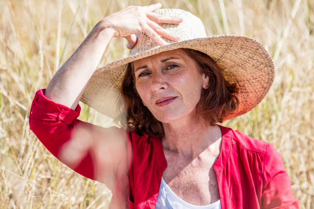 mature lady wearing sun hat