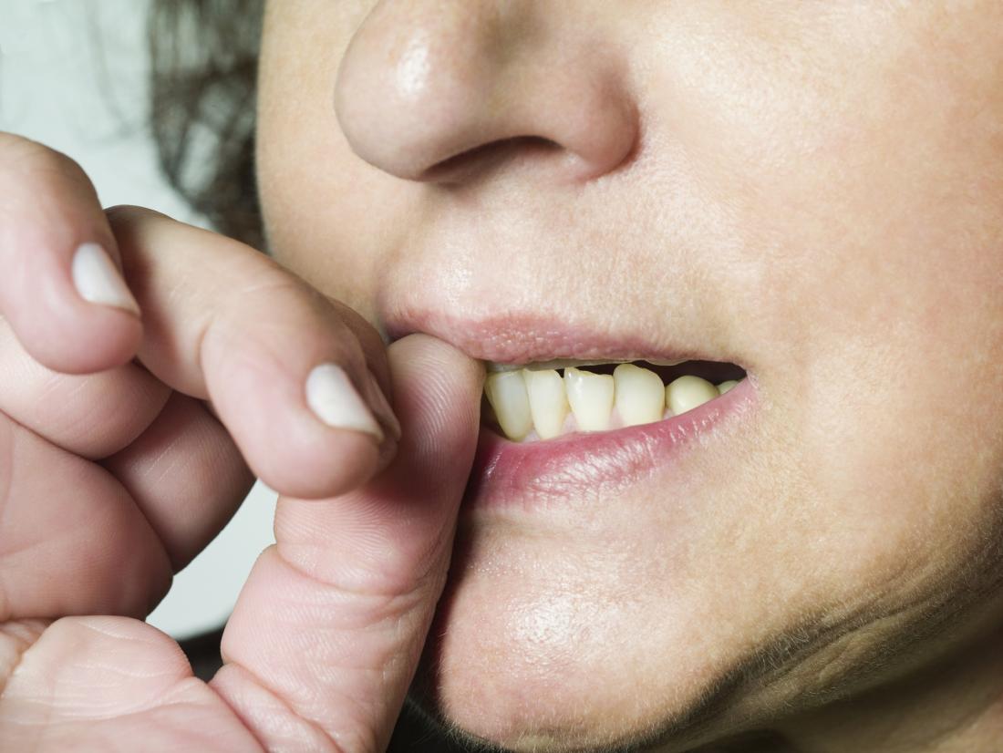 Anxious woman biting nails