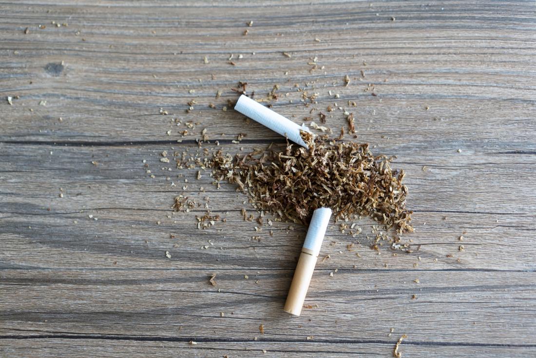 quitting smoking represented by broken cigarette on table