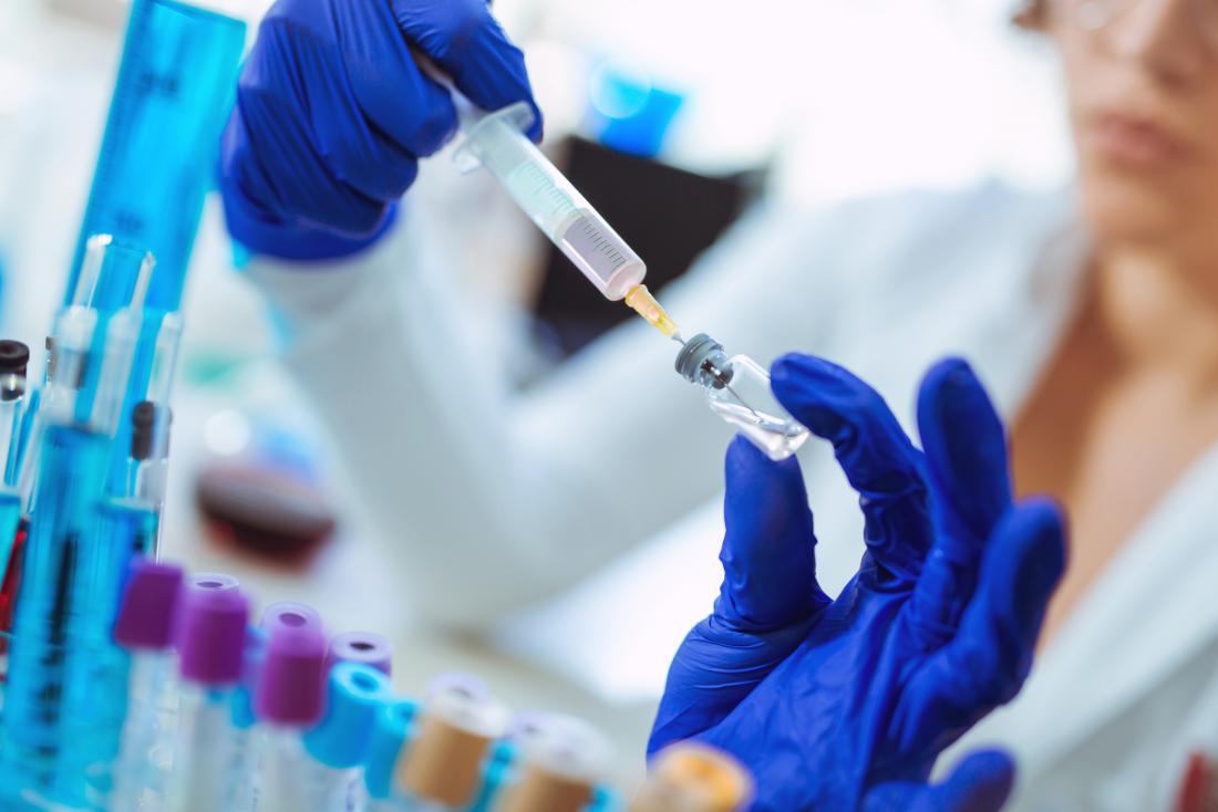 researcher with experimental vaccine