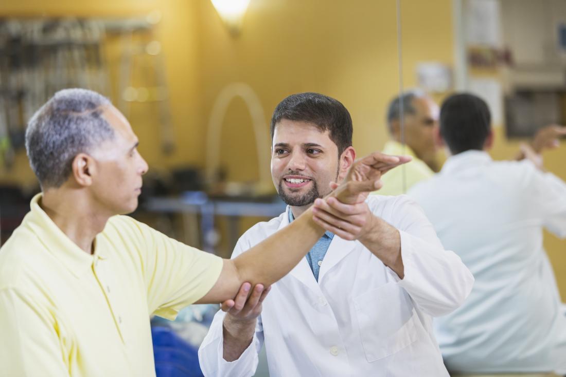 Man receiving physical therapy treatment for elbow pain