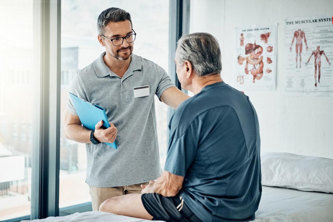 Physical therapist talking with patient