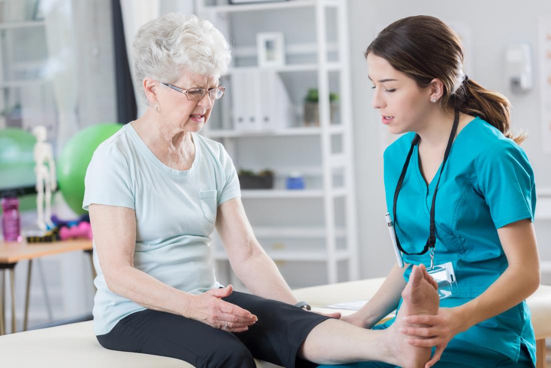 Senior woman having physical therapy on her leg