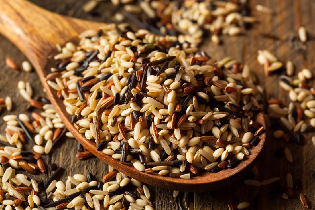 Wild rice on a spoon which is a food to avoid for crohn's disease