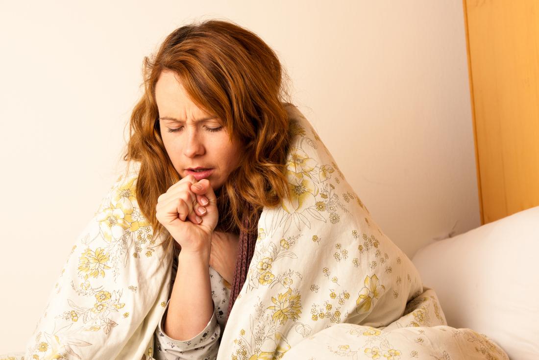 woman coughing due to the flu or bronchopneumonia