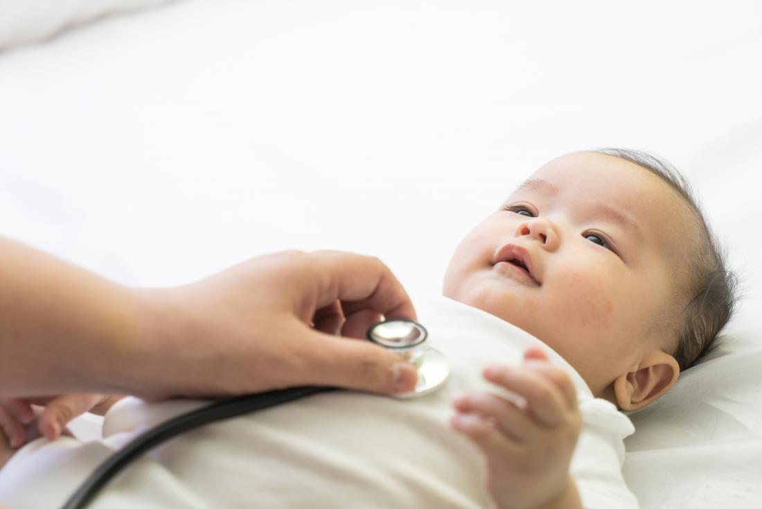 doctor using stethoscope on baby