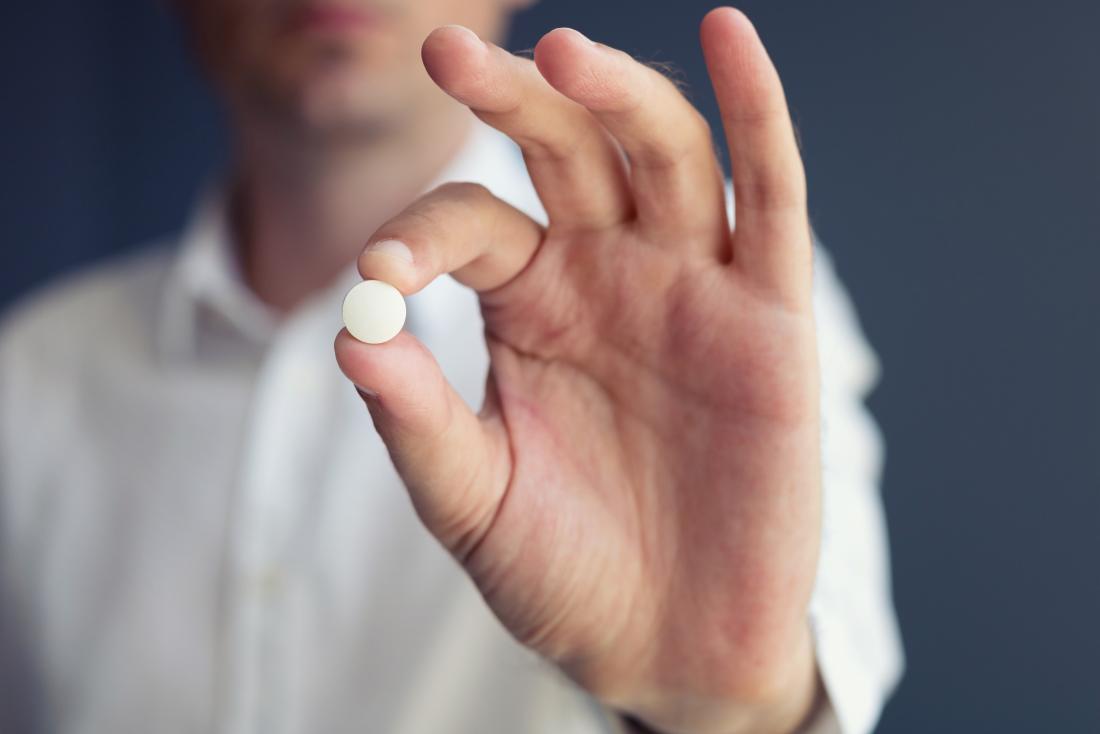 man showing a pill