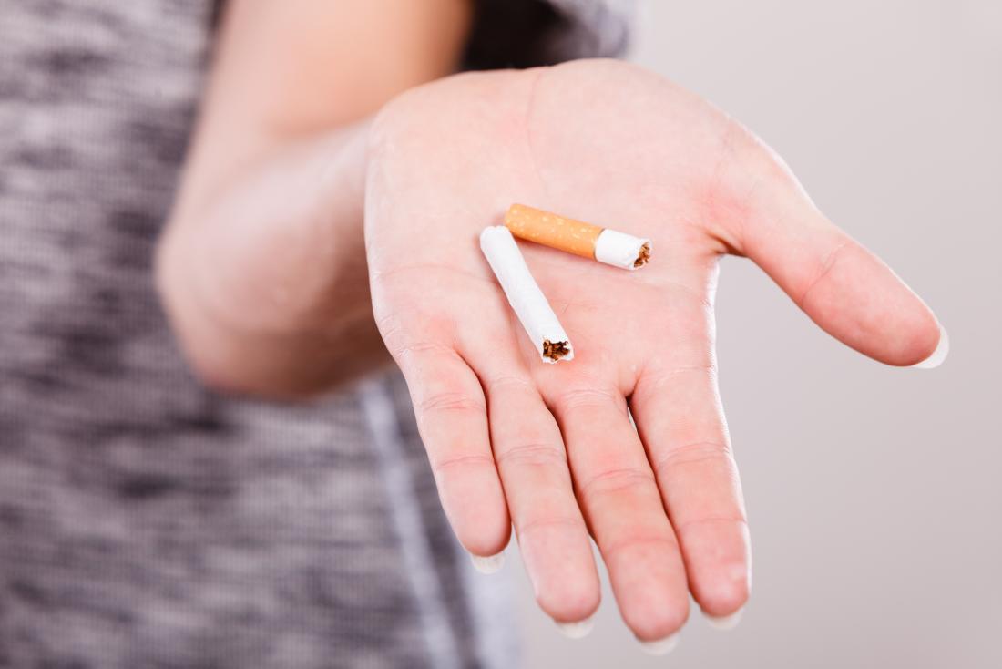 woman shows a broken cigarette