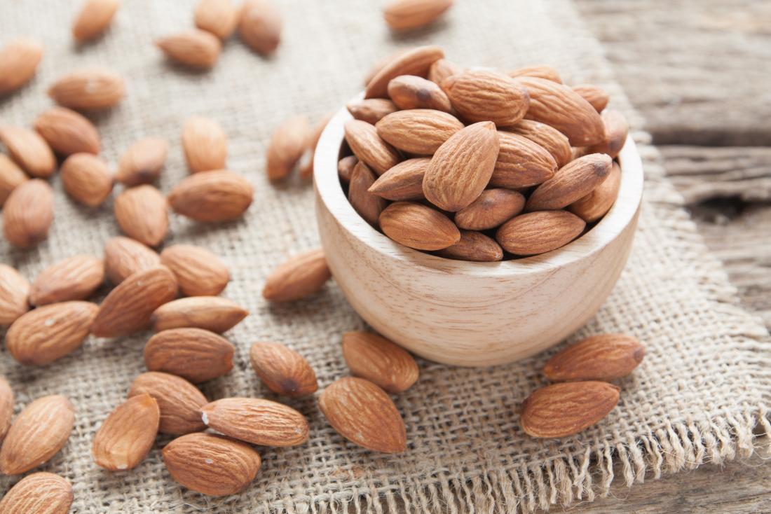 Almond nuts in wooden bowl
