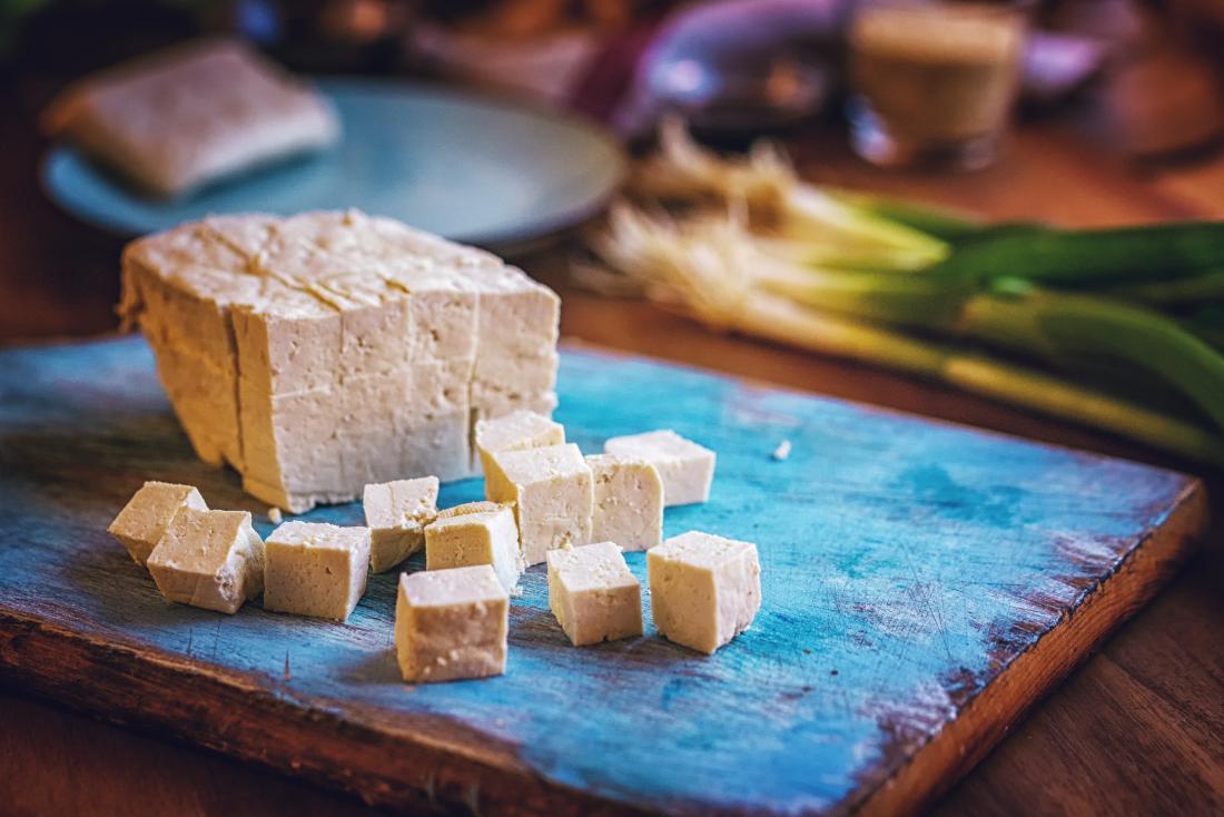 Block of tofu on chopping board