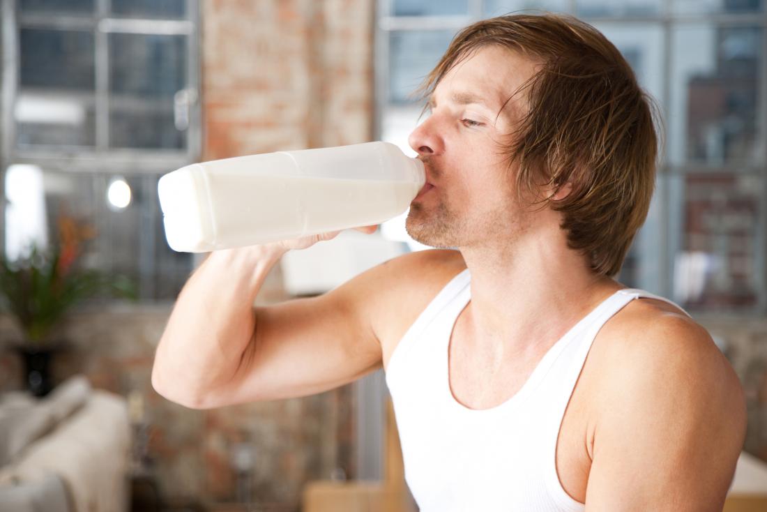 Man drinking from carton of milk