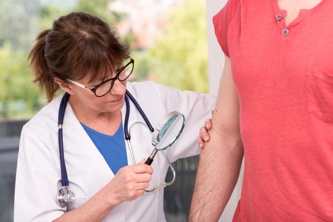 dermatologist examining patients skin