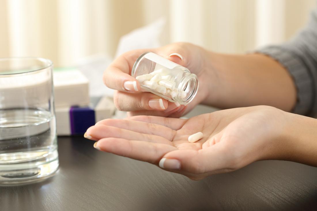 a woman taking a pill