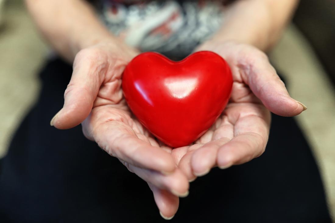 person holding heart figurine