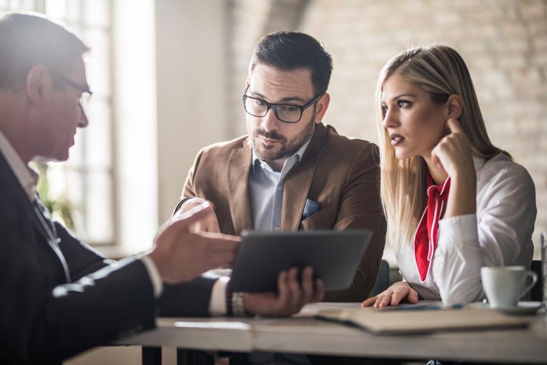 Insurance broker talks to couple