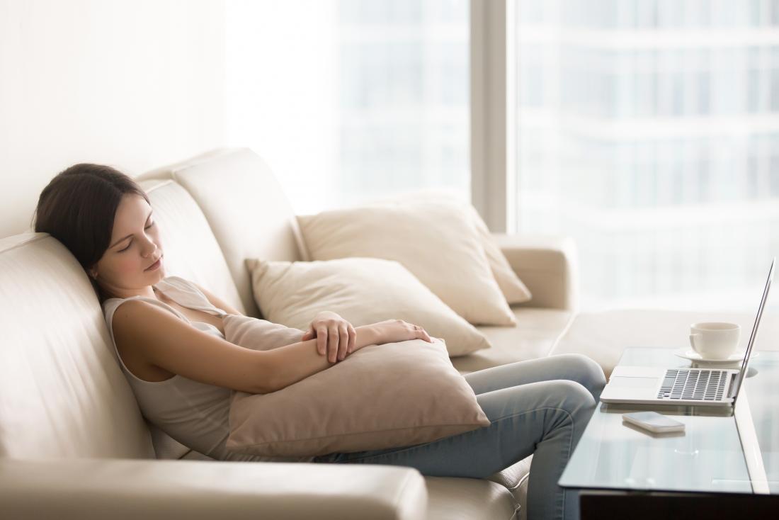 sleepy young woman sitting on settee