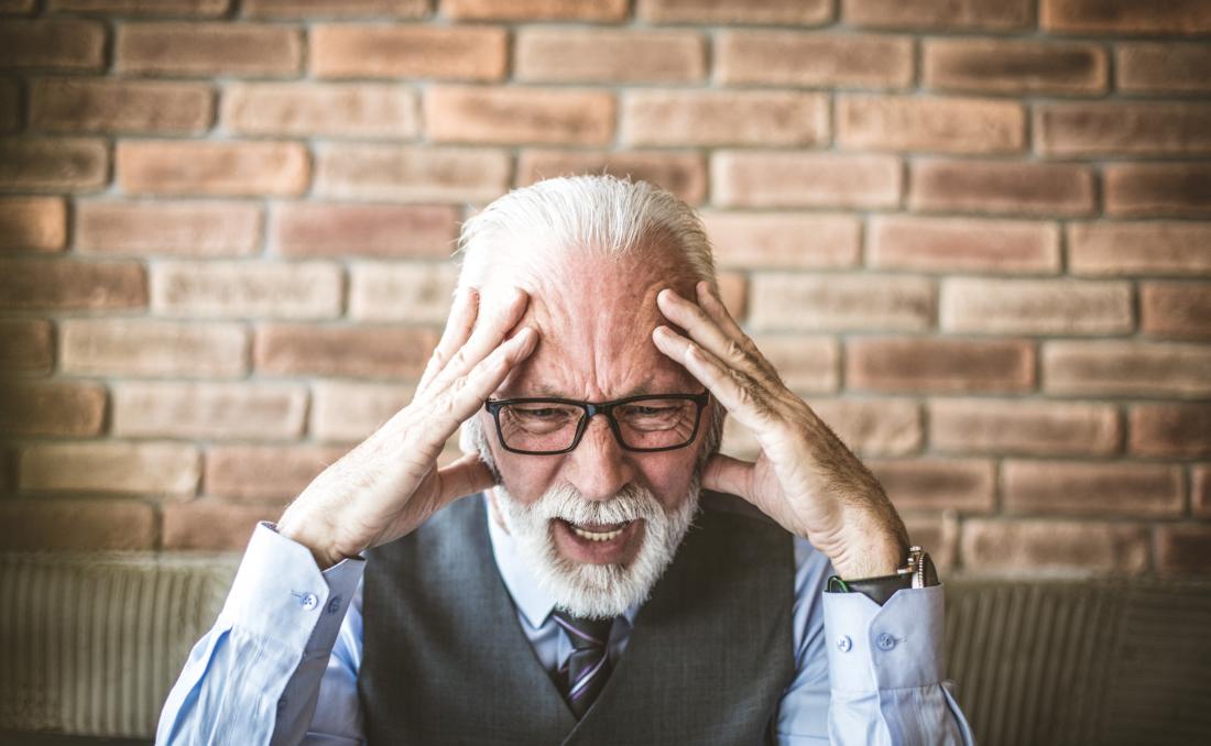 mature man holding his head
