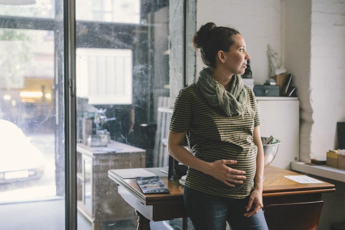 Pregnant woman holding baby bump