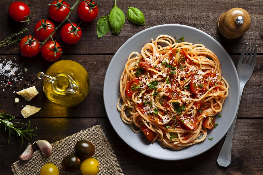 Tomato spaghetti pasta dish with olive oil, tomato, garlic, and cheese