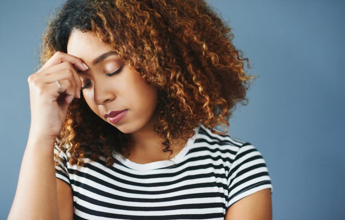 Woman with stress holding her forehead