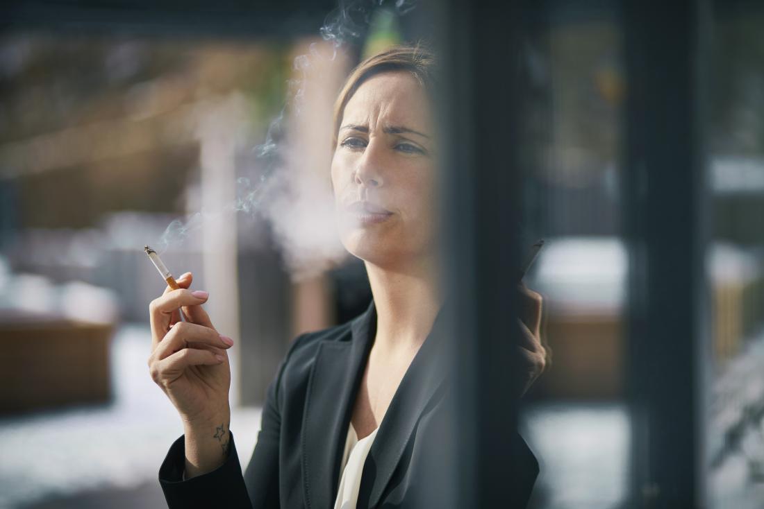 Business woman smoking cigarette