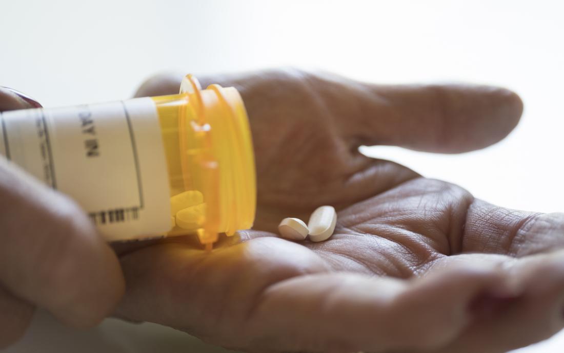 Medication being tipped out of pot into palm