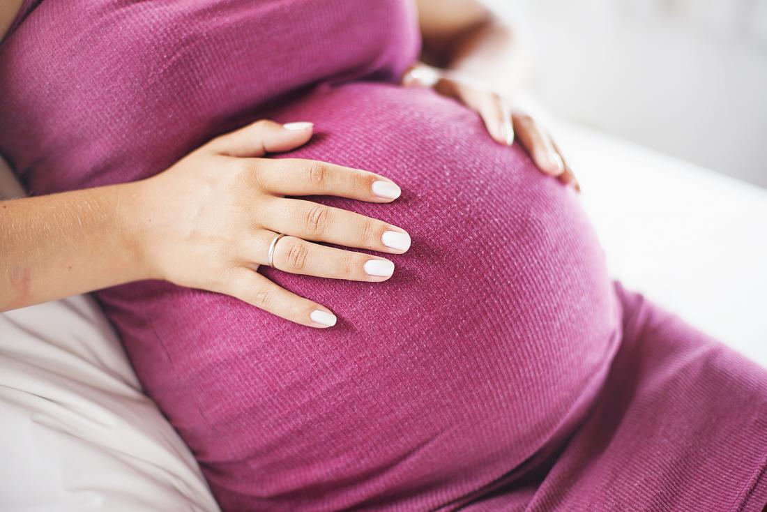 pregnant woman with hands on belly