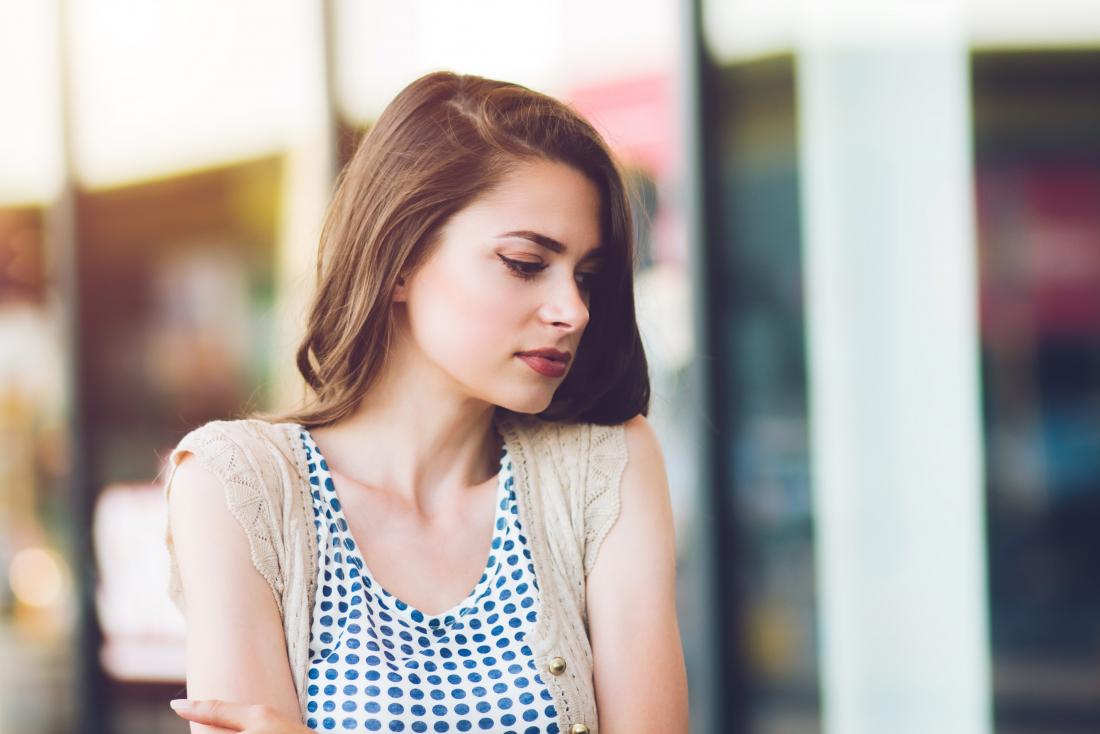 young woman looking in window