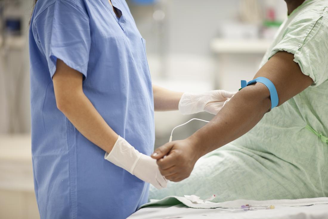 Person giving blood sample.