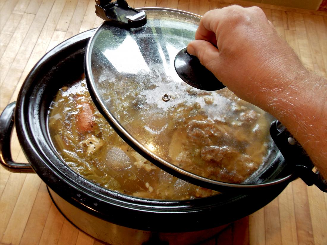 Chicken soup stock being made into a slow cooker