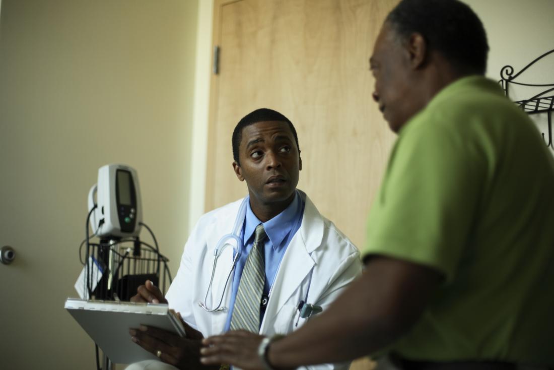Man with HIv complications describing symptoms to doctor