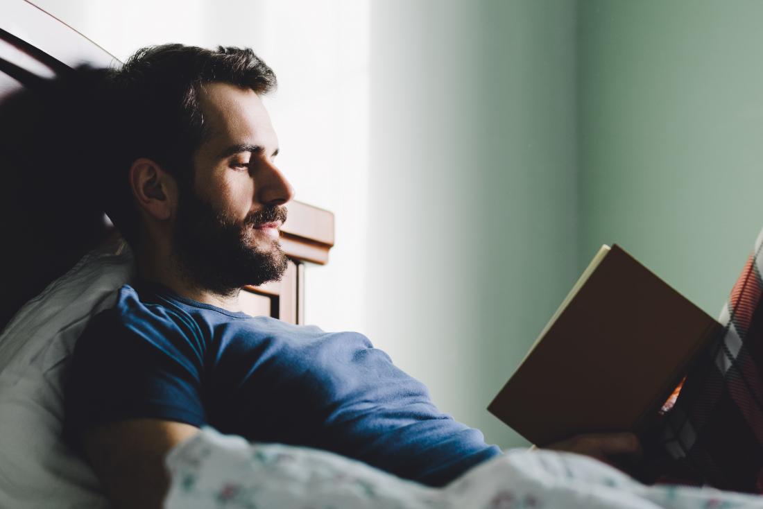 man reading in bed