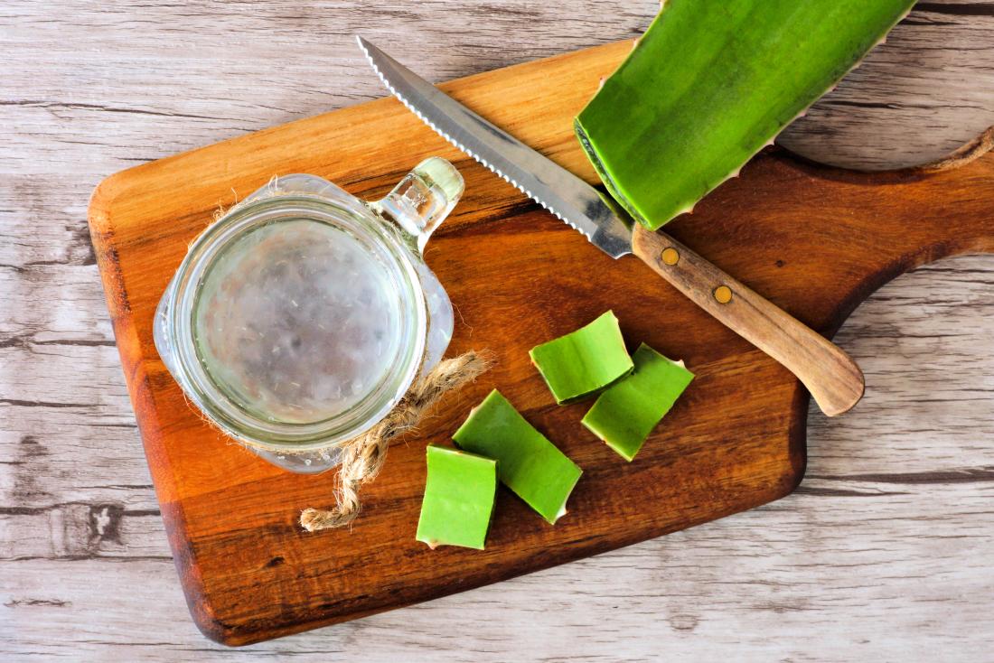 Jugo de aloe vera en tarro de albañil y tabla de cortar