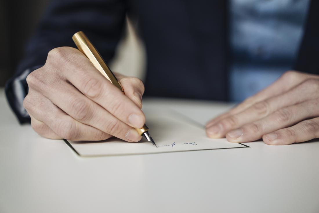 Person writing by hand.