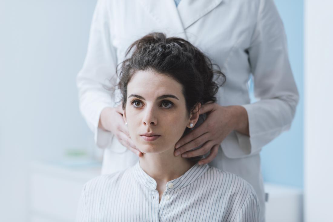 doctor examining female patients lymph nodes