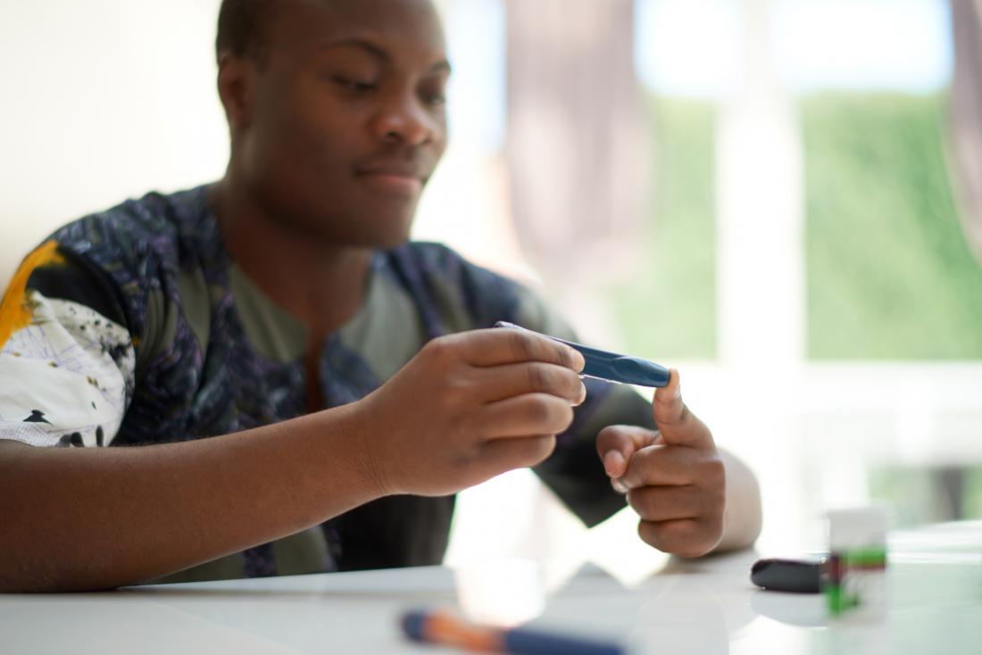 person taking blood glucose test
