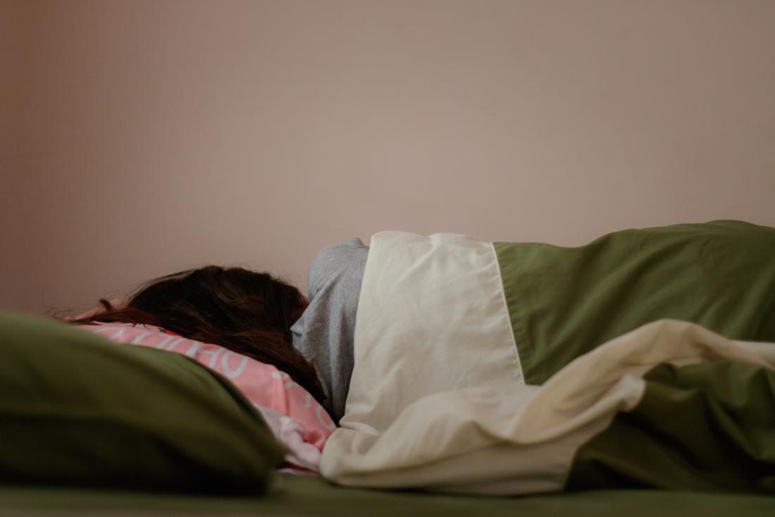 woman sleeping with face to wall