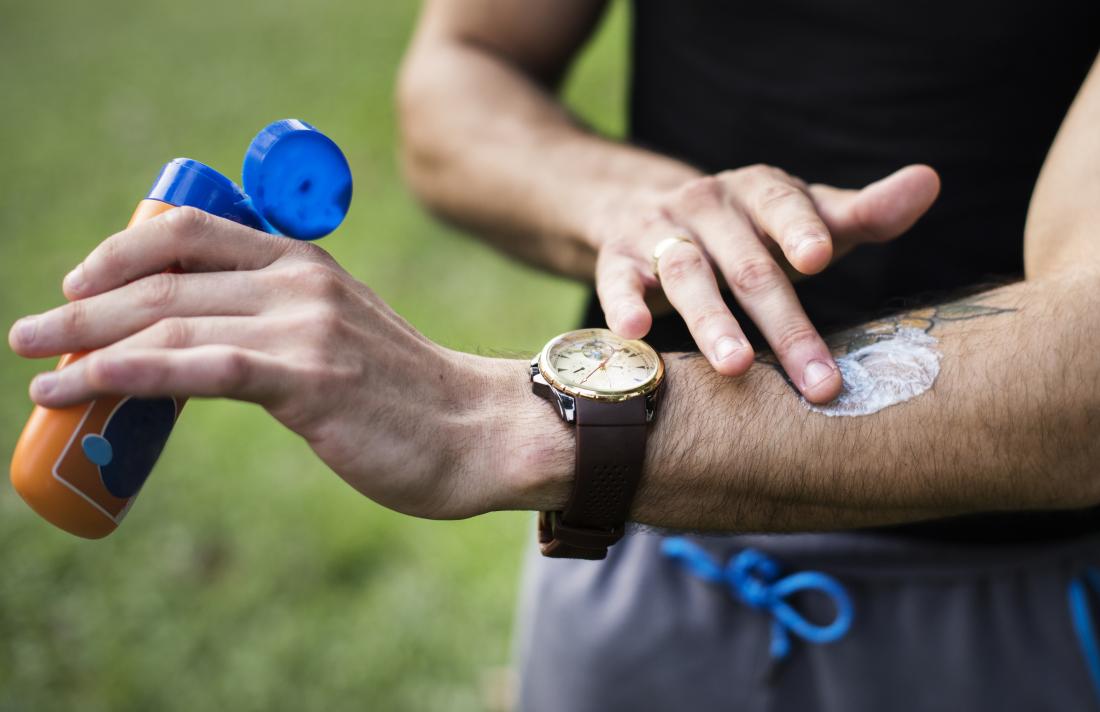 Person applying sunscreen to arm