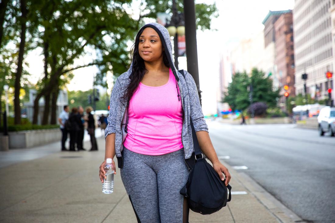 Woman walking through a city in sport gear