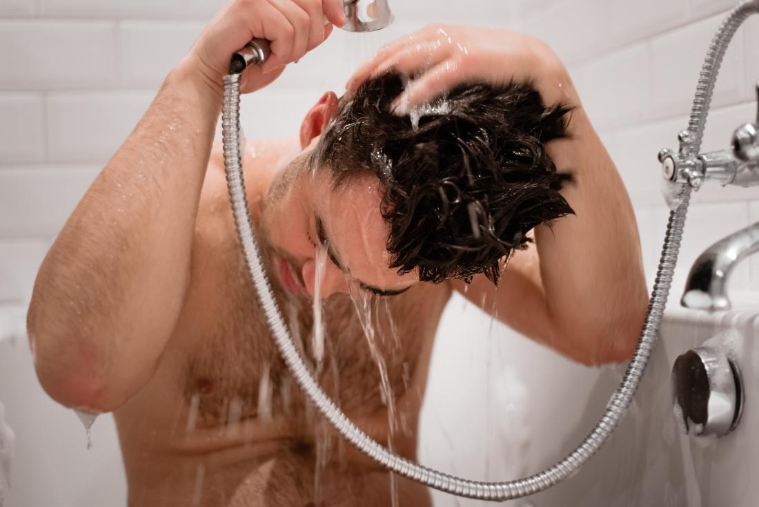 man washing his hair in the shower