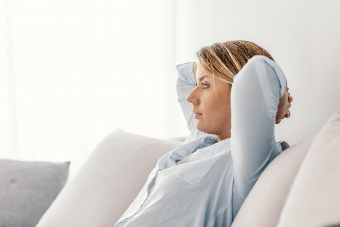 woman sat on her sofa working out her respiratory rate