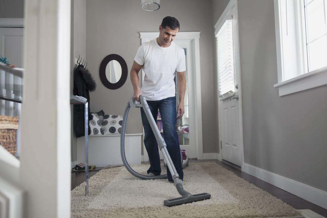 Man vacuuming house with hoover