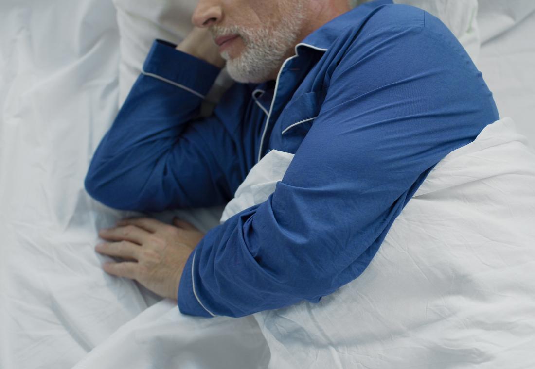 Older man asleep in pajamas