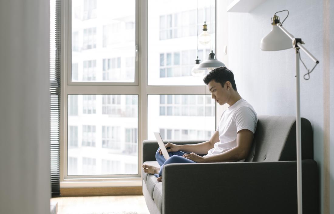 MAn sitting on sofa or couch on lapatop