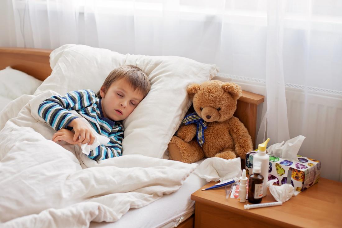 little boy with a cold asleep in bed