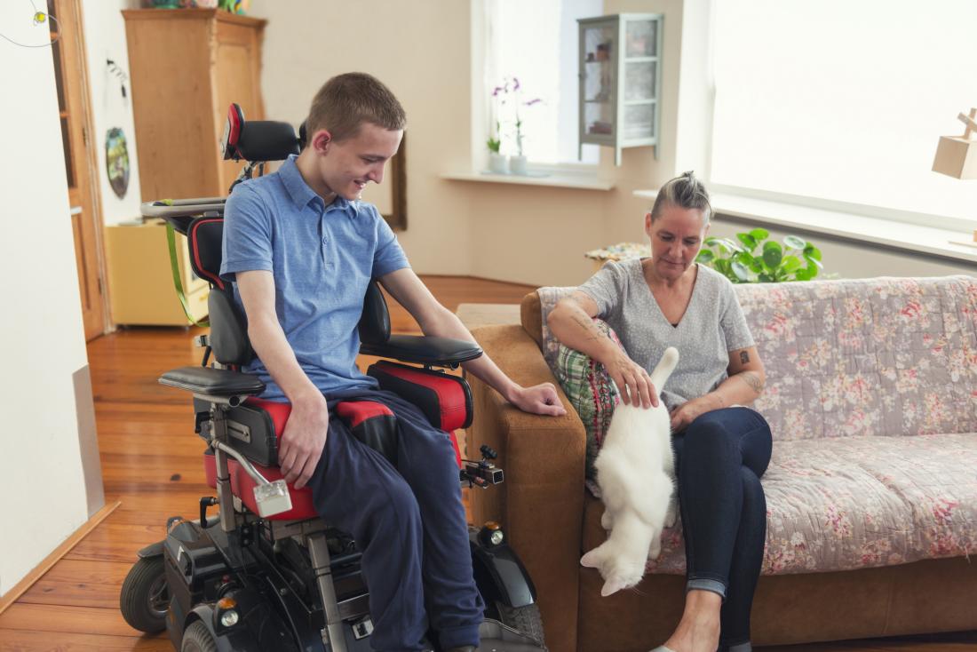person with ALS playing with dog
