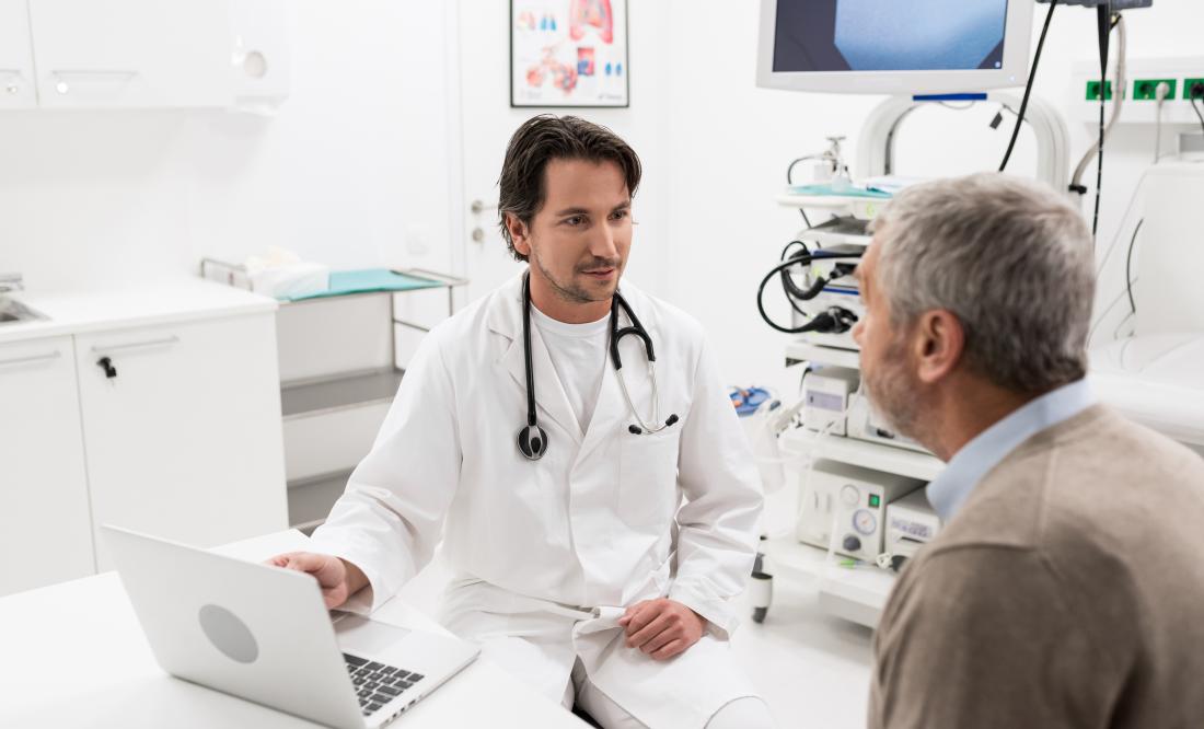 senior man speaking to young male doctor