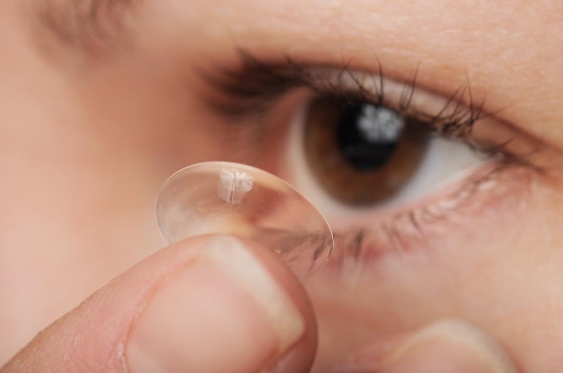 close up of contact lens being put in eye