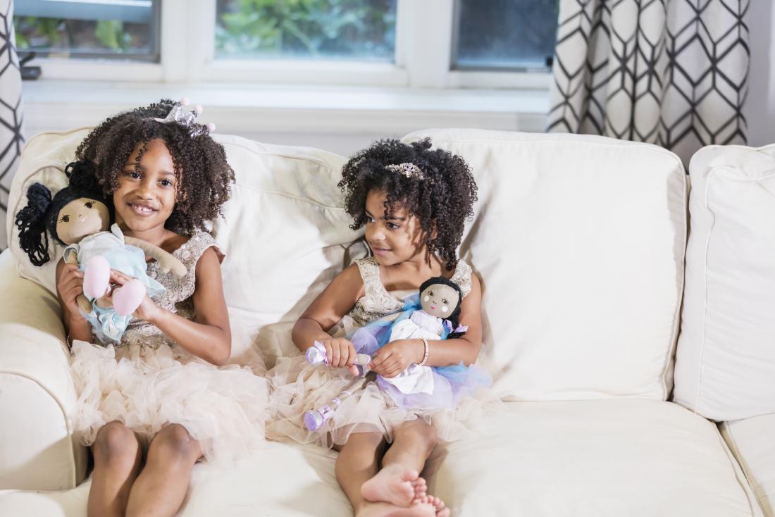 two girls in tutus holding rag dolls