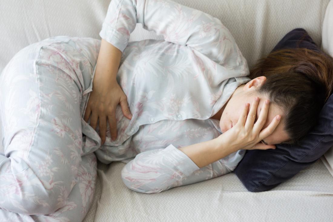woman in pain holding her abdomen